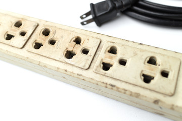 Old and unsafe power strip with illuminated switch isolated on white background