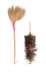 Brown grass broom and feather duster isolated on white background