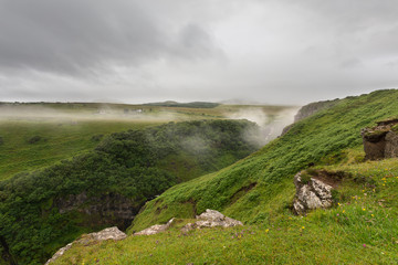 Landscape of the misty valley in Isle of Skye with dark clouds