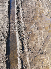Winter melting snow on the road closeup, early spring