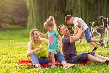 Young family with children having fun in nature.