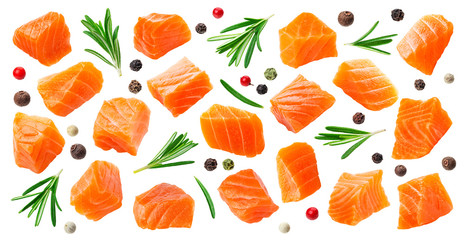 Salmon slices isolated on white background with clipping path, cubes of red fish with rosemary and peppercorns, ingredient for sushi or salad