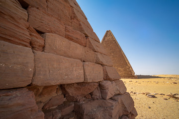 Close-up view of a pyramid of the black pharaohs in Sudan with a view of a farther pyramid in the...