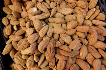 Fototapeta premium Organic almond nuts as background, top view. Healthy snack