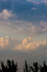 Landscape with dramatic light - beautiful golden sunset with saturated sky and clouds.