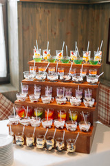 Delicious sweets on wedding candy buffet with desserts, cupcakes
