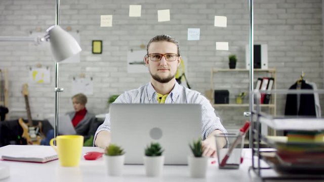Annoyed angry businessman troubled with sudden computer failure, stressed man having problem with broken pc using laptop, pressing keys on hanging device, leaving workplace unable to fix gadget