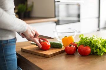 Young trendy woman cooking healthy food in the morning