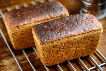 Freshly baked rye bread cools on a grill