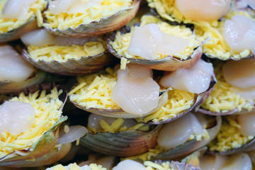Broiled scallops with cheese on the shell at a fish market in Sydney, Australia