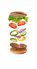  Delicious burger with flying ingredients. Cooking fast food.