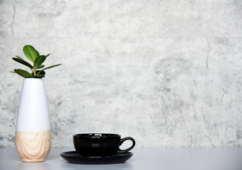 Black coffee cup with vase on the table Copy space