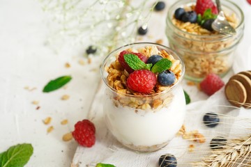 Healthy Breakfast Granola Yogurt Parfait with fresh fruits and berries, selective focus