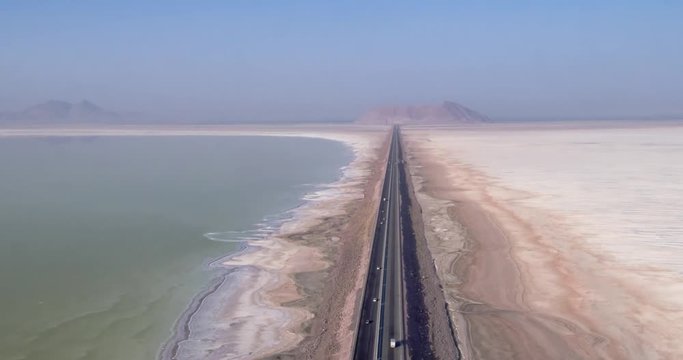 Aerial photography. From a bird's eye view of the road that crosses the salty lake Urmia, Iran. 4k.