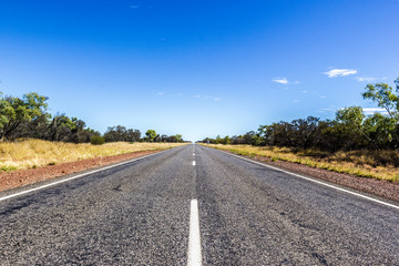 Fototapeta na wymiar straight road through the dessert of Australia, South Australia, Stuart Highway Australia