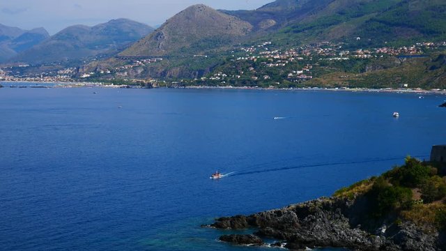 San Nicola Arcella, Calabria, Italy - September 6 2018: Dino island, Crawford tower (watchtower) and boats on Mediterranean sea (Tyrrhenian)