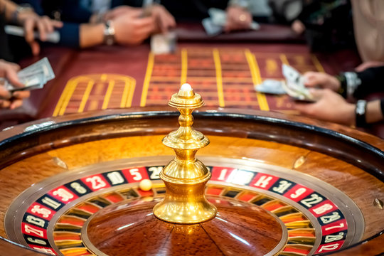 Casino. Roulette with players. Gambling People make bets on roulette. Win. Cash games.