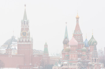 Winter day. Heavy snowfall. Blizzard. Spasskaya Tower of Moscow Kremlin and the Cathedral of Vasily the Blessed (Saint Basil's Cathedral) on Red Square. Moscow. Russia