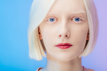 awesome beautiful albino with makeup and blue eyes looking at the camera, close up photo. isolted...