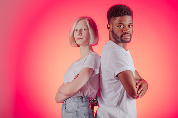 Fototapeta premium beautiful girl and handsome man standing with crossed arms, close up photo. lifestyle, confidence