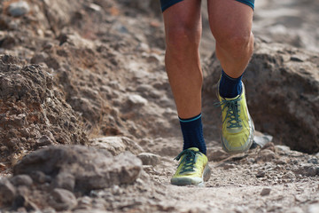 Trail running action close up of running shoes in action