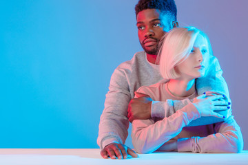closeness, thoughtful, pensive man and woman hugging each other while sitting at the table, close up photo, copy space