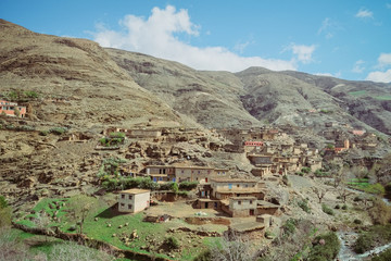 A small village with old flat mud terrace roof buildings in the rural area of Atlas mountain range. Morocco.