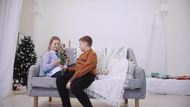 Boy gives flowers to girl