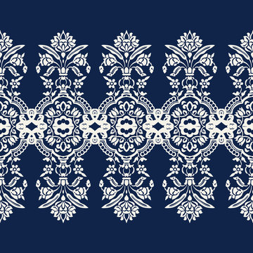 Woodblock printed indigo dye seamless ethnic floral caleidoscope geometric border. Traditional oriental ornament of India Kashmir, ecru on navy blue background. Textile design.