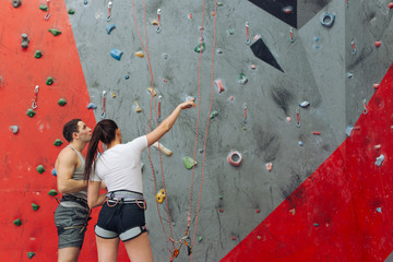 pleasant couple discussing the future route before climbing. rare view. copy space