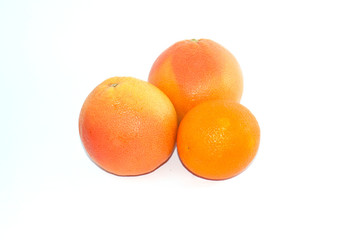 Two grapefruit and an orange on a white background isolate copy space