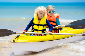 Obraz premium Kids kayaking in ocean. Children in kayak in tropical sea