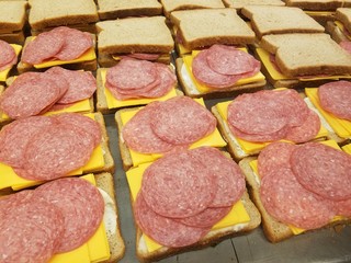 Salami and cheese sandwiches in progress