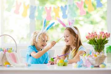 Kids on Easter egg hunt. Children dye eggs.