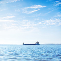 big ship on the river and blue sky with clouds above it