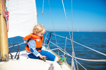 Kids sail on yacht in sea. Child sailing on boat.