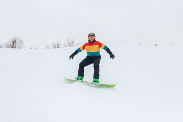 ambitious man is good at snowboarding, favourite hobby, pastime, full length photo.
