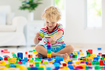 Child playing with toy blocks. Toys for kids.