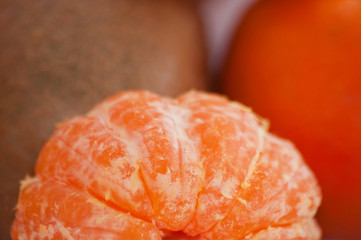 Delicious juicy peeled mandarin close-up macro
