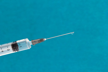 medical syringe with medicine on a blue background