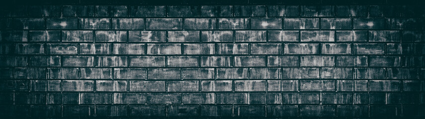 Wide old black shabby brick wall texture. Dark aged masonry panorama. Brickwork panoramic grunge...