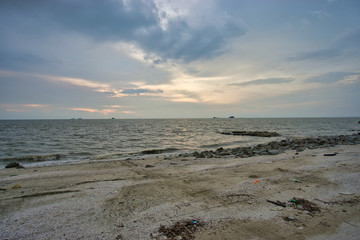 Fototapeta na wymiar Peaceful beach view and waves during sunset at Jeram, Kuala Selangor Malaysia