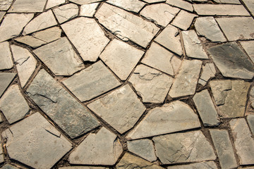 Close-up of the Texture of the Ground Paved with Bricks and Stones
