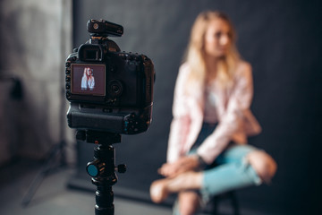close up photo, focus on a working digital camera at the studio, blurred background