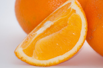 Orange on white background, juicy fruit slice close up