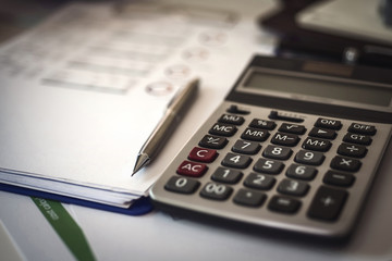 Calculator for Invoice on workplace of accountant Business. Accounting concept.