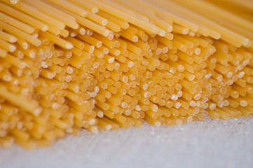 Raw spaghetti on a gray background close-up top view side macro
