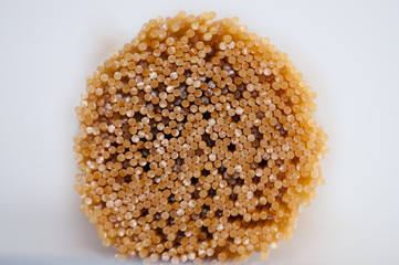 Raw spaghetti on a gray background close-up top view side macro