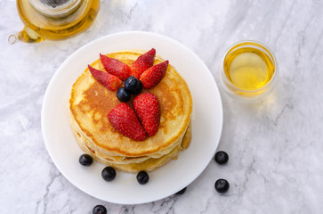 Pancakes with strawberry and blueberry on top