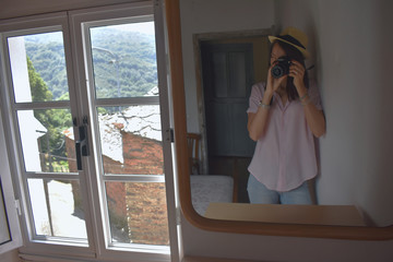 Chica haciendo foto al espejo, ventana antigua, paisaje, montaña
